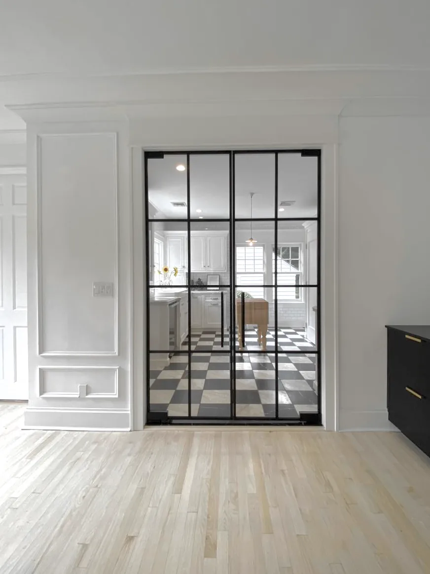 French glass doors with multi-pane grid and exposed pivot hinges by WiseGlass NY
