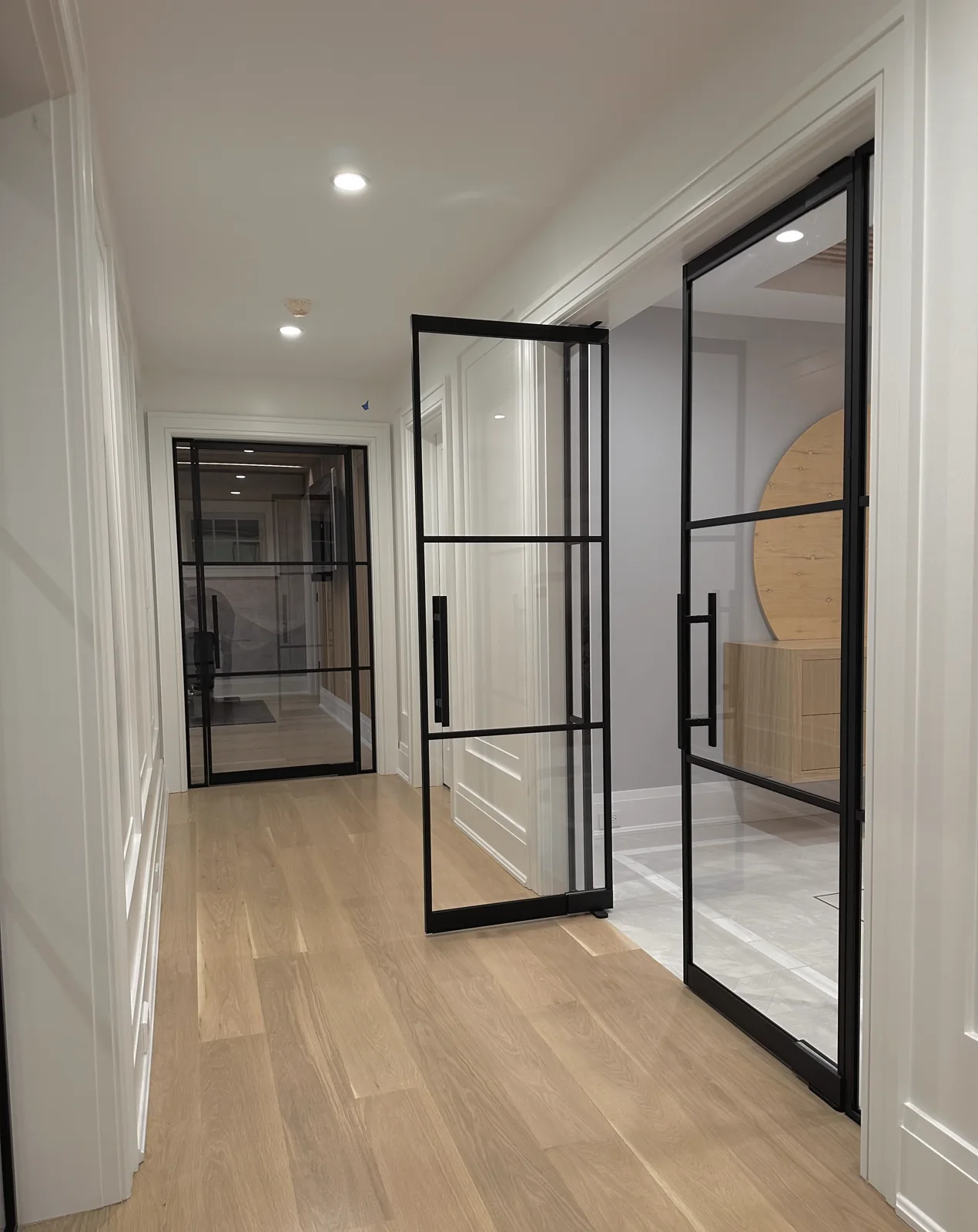 French doors with sidelights beside a single swing door by WiseGlass NY