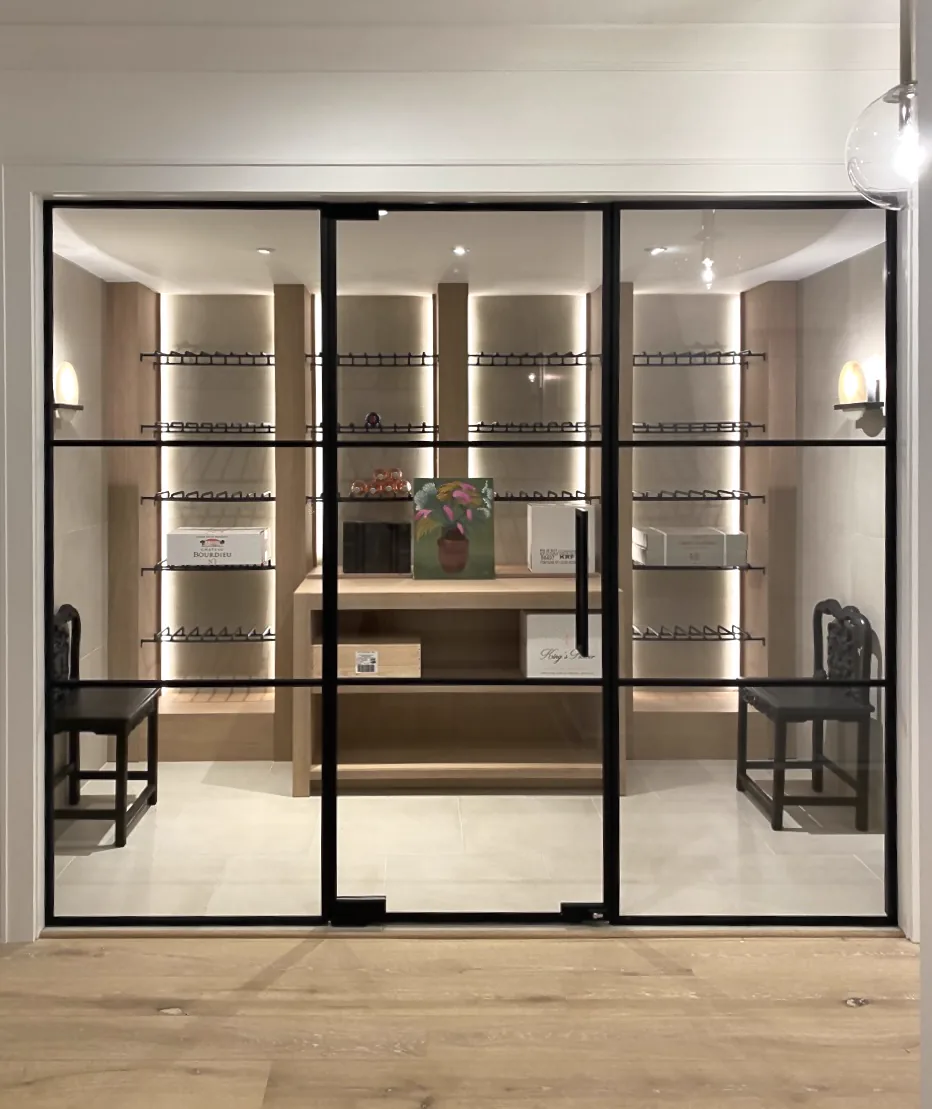 Glass partition wall with single swing door at wine room entrance by WiseGlass NY