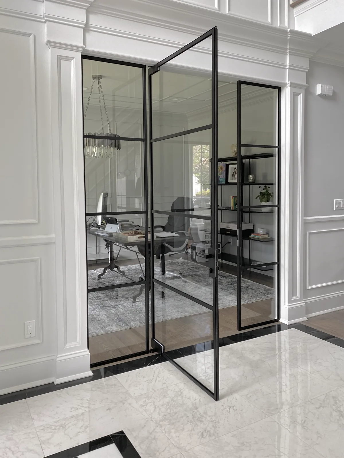 Glass partition wall with single swing door at office entrance by WiseGlass NY