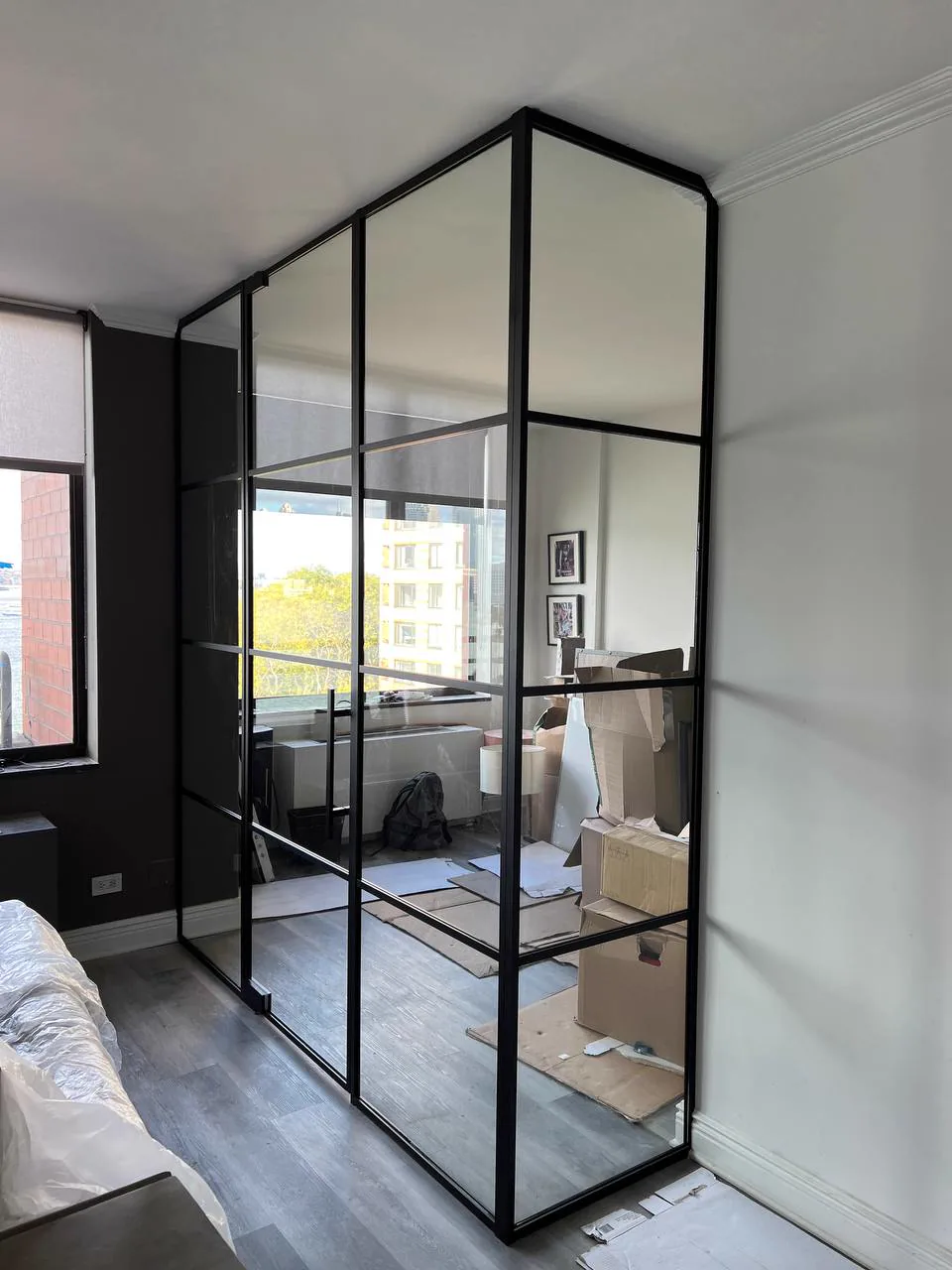 L-shaped glass partition wall with single swing door by WiseGlass NY