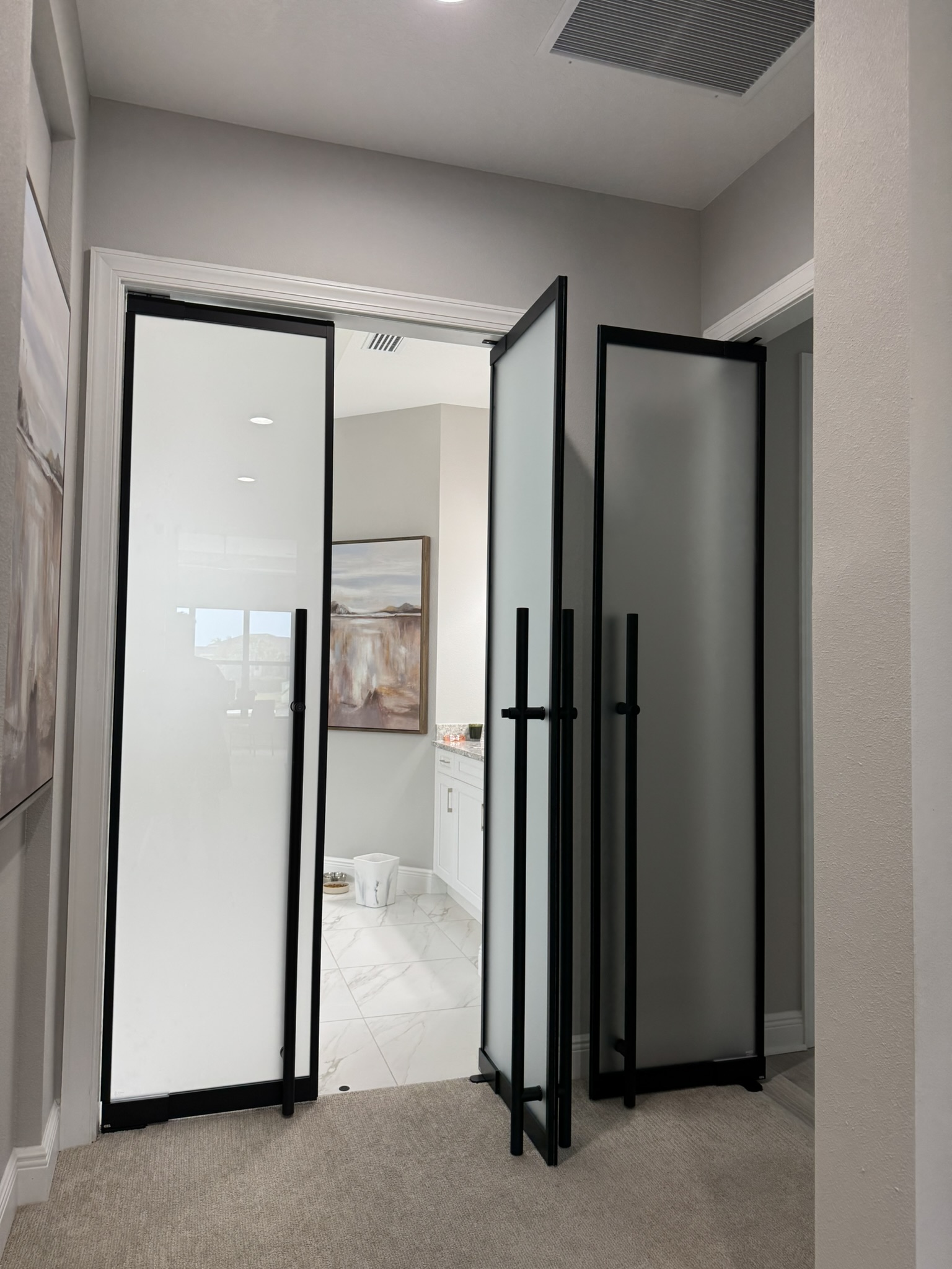 Frosted glass bi-fold swinging doors by WiseGlass NY